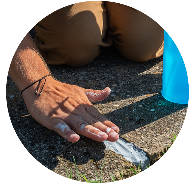 Smoothing concrete caulk between two concrete slabs