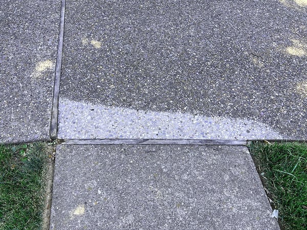 Sidewalk trip hazard after grinding down slab to be even with adjoining slabs