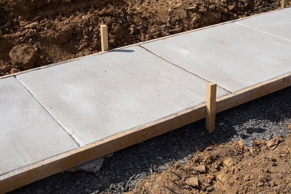 Concrete sidewalk poured into wooden forms