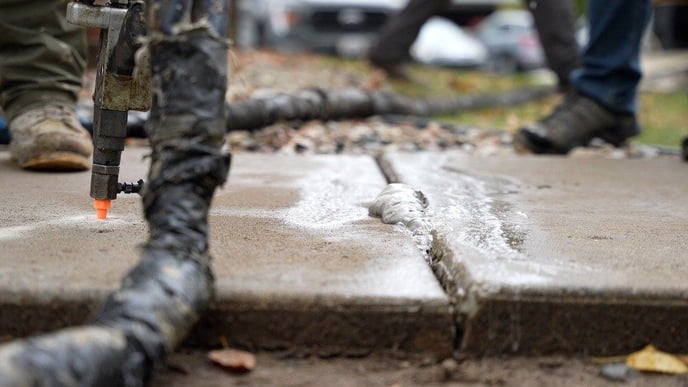 Foam used to lift concrete sidewalk coming out of crack