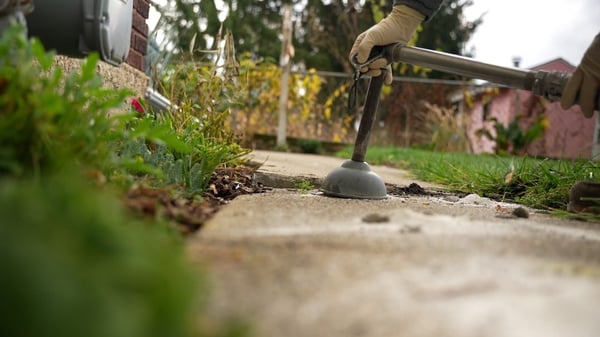 Using stone slurry grout concrete leveling to fix sidewalk trip hazard