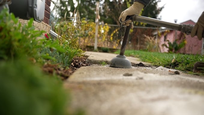 Using stone slurry grout concrete leveling to fix sidewalk trip hazard