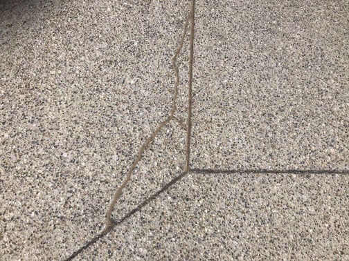 Aggregate concrete slab with repaired cracks