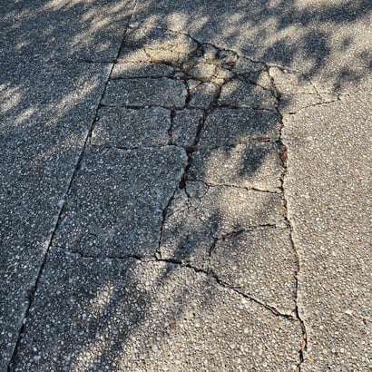 Concrete driveway with multiple breaks throughout