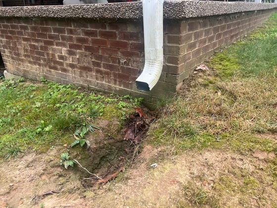 Downspout elbow attached to porch causing erosion next to foundation