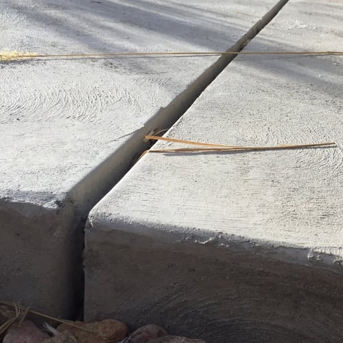 Concrete expansion joint between two driveway slabs with nothing filling them