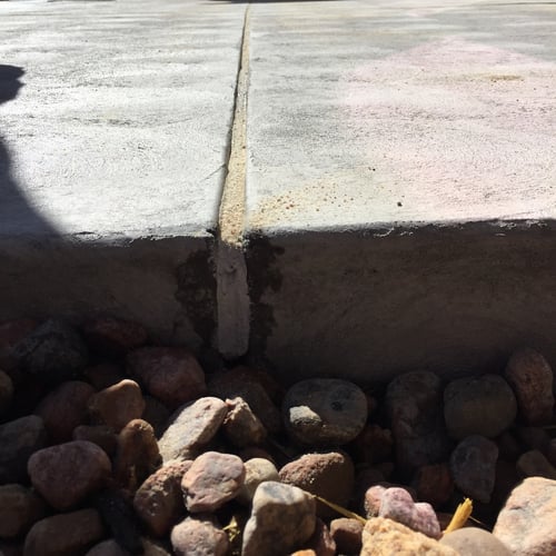 Concrete expansion joint filled with flexible concrete caulk to allow for movement between slabs