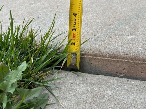 Expansion joint between two concrete slabs that have allowed for independent movement without cracking