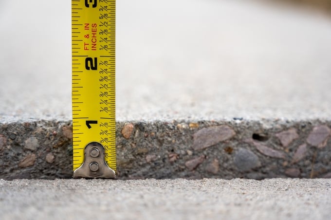 Tape measure next to concrete trip hazard