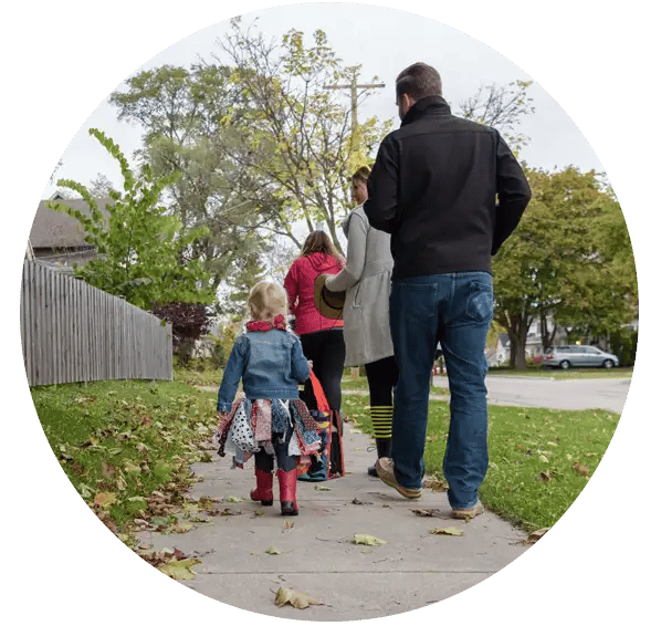 family-walking-on-sidewalk